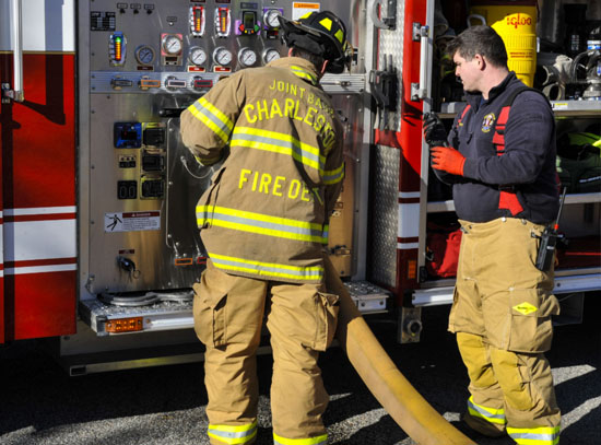 Picture of Firemen behind truck