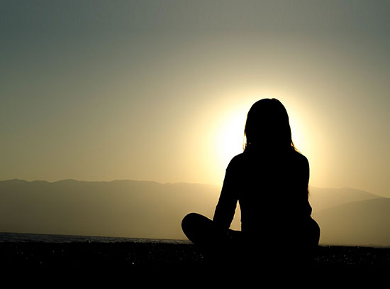 Picture of a girl sitting on a hill contemplating life